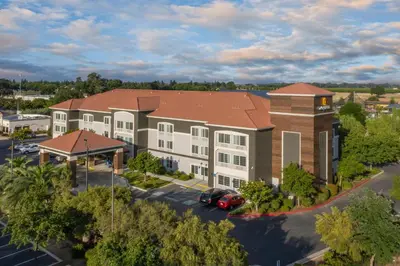 an aerial view of a building with a car in a parking lot at La Quinta by Wyndham Visalia/Sequoia Gateway in Visalia