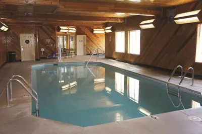 a swimming pool in a house with wooden walls at La Quinta by Wyndham Visalia/Sequoia Gateway in Visalia