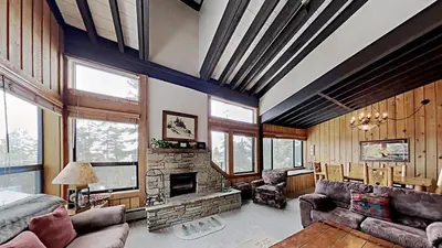 a living room with a couch and a fireplace at Warm and Cozy 4 Bedroom Condo in Mammoth! in Mammoth Lakes