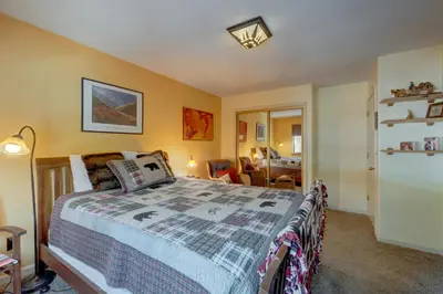 a bedroom with a bed and a living room at Serventi Tahoe Donner Cabin in Truckee