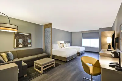 a hotel room with a bed and a couch at Hyatt Place Fresno in Fresno
