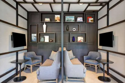 a waiting room with chairs and televisions at Hyatt Place Fresno in Fresno