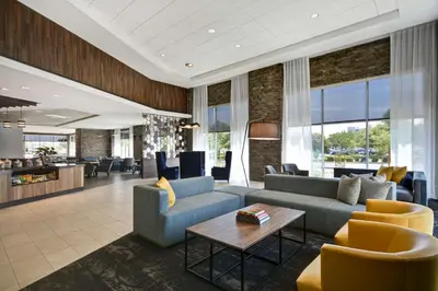 a living room with couches and a table at Hyatt Place Fresno in Fresno