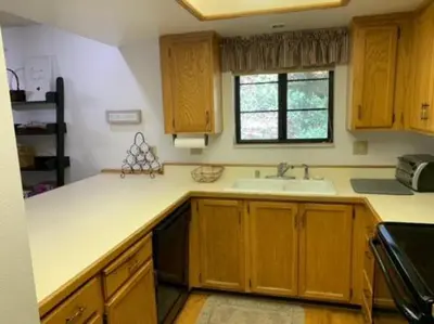 a kitchen with wooden cabinets and a sink and a window at Rr-interlaken 13 in June Lake