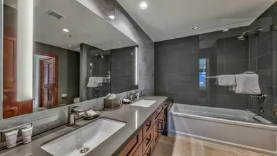 a bathroom with two sinks and a large mirror at Luxury 2Br Residence Steps From Heavenly Village & Gondola Condo in South Lake Tahoe