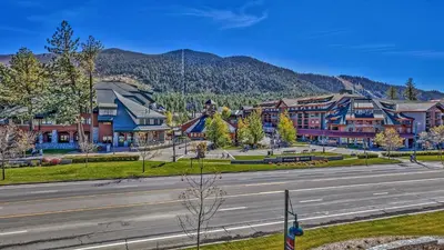 an empty street in a town with mountains in the background at Luxury 2Br Residence Steps From Heavenly Village & Gondola Condo in South Lake Tahoe
