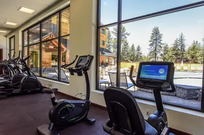 a gym with cardio equipment and a large window at Luxury Residence - Gondola Across The Street Condo in South Lake Tahoe