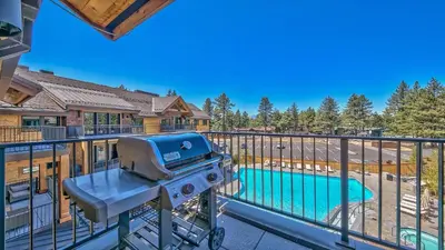 a grill on a balcony next to a swimming pool at Luxury Residence - Gondola Across The Street Condo in South Lake Tahoe