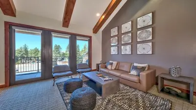 a living room with a couch and a table at Luxury Residence - Gondola Across The Street Condo in South Lake Tahoe