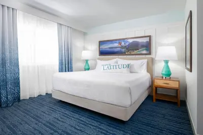 a hotel room with a large white bed and two lamps at Margaritaville Resort Lake Tahoe in South Lake Tahoe