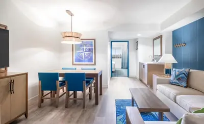 a living room and dining room with a table and blue chairs at Margaritaville Resort Lake Tahoe in South Lake Tahoe