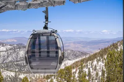 a gondola flying over a snow covered mountain at Margaritaville Resort Lake Tahoe in South Lake Tahoe