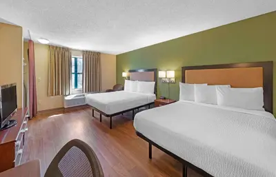 a hotel room with two beds and a television at Extended Stay America Suites - Sacramento - Roseville in Roseville