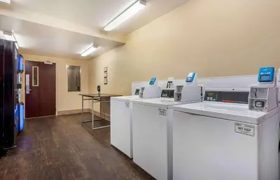 a laundry room with washers and dryers in a building at Extended Stay America Suites - Sacramento - Roseville in Roseville