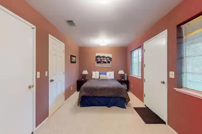 a bedroom with orange walls and a bed in a room at Escape to Yosemite in Groveland