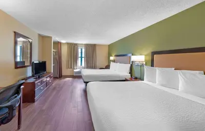 a hotel room with two beds and a flat screen tv at Extended Stay America Suites - Sacramento - White Rock Rd in Rancho Cordova