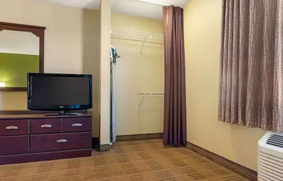 a hotel room with a tv and a dresser with a dresser at Extended Stay America Suites - Reno - South Meadows in Reno