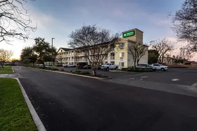 an empty street in front of a hotel at HomeTowne Studios by Red Roof Fresno - West in Fresno