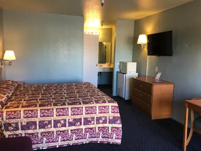 a hotel room with a bed and a television at Applegate Inn in Atwater