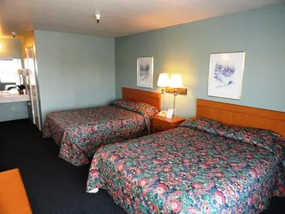 a hotel room with two beds in a room at Applegate Inn in Atwater