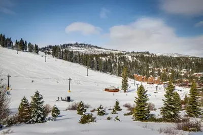 a snow covered slope with a ski resort and trees at Welcoming Tahoe-Donner Cabin in Truckee