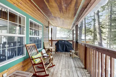 a porch with two rocking chairs on a house at Welcoming Tahoe-Donner Cabin in Truckee