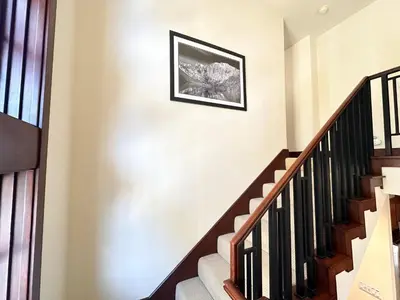 a staircase in a house with a picture on the wall at Juniper Crest #25 Condo in Mammoth Lakes