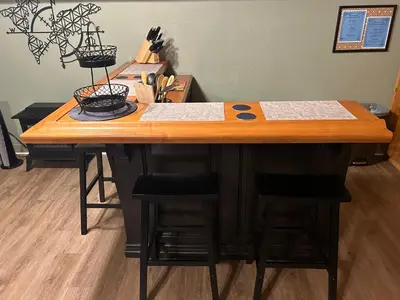 a wooden table with stools in a room at Kin House Guest Suite in Oakhurst