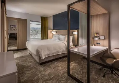 a hotel room with a bed and a bath tub at SpringHill Suites by Marriott Reno in Reno