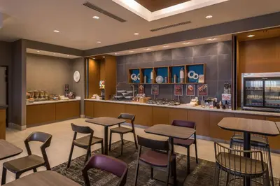 a restaurant with tables and chairs and a counter at SpringHill Suites by Marriott Reno in Reno