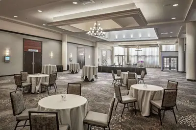 a banquet hall with tables and chairs in a room at Hilton Sacramento Arden West in Sacramento