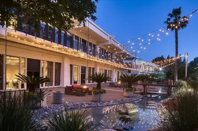 a building with a courtyard with a pond and lights at DoubleTree By Hilton Sacramento in Sacramento