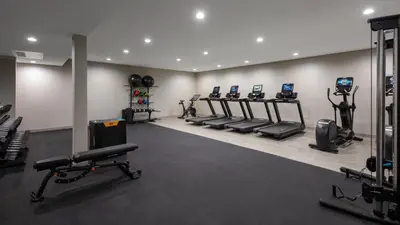 a gym with rows of treadmills and machines at DoubleTree By Hilton Sacramento in Sacramento