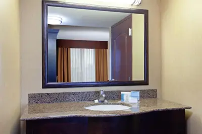 a bathroom with a sink and a large mirror at Hampton Inn & Suites Fresno - Northwest in Herndon