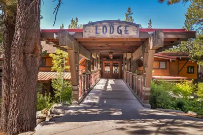 a building with a sign that reads lodge at The Acorn House in Truckee