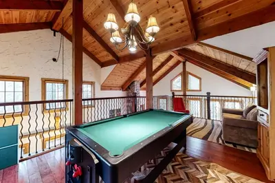 a pool table in a room with wooden ceilings at The Acorn House in Truckee