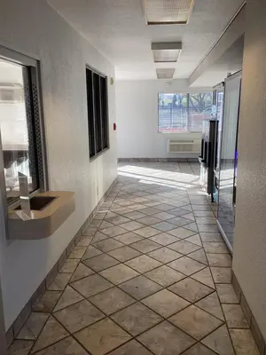 a hallway with a tile floor in a building at Motel 6-Reno, NV - Livestock Events Center in Reno
