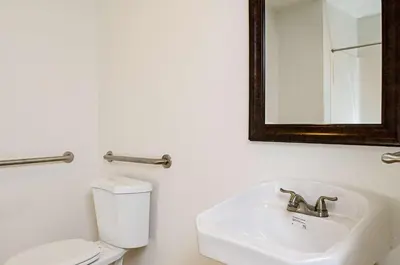 a bathroom with a toilet and a sink and a mirror at Motel 6-Modesto, CA - Downtown in Modesto