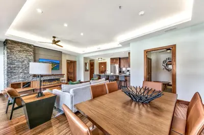 a living room with a table and a couch at Luxury 2Br Residence Steps From Heavenly Village & Gondola Condo in South Lake Tahoe