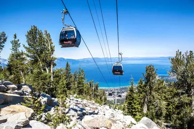 a group of gondolas flying over a mountain at Luxury 2Br Residence Steps From Heavenly Village & Gondola Condo in South Lake Tahoe