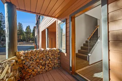 a stack of fire wood on the side of a house at Mammoth Village Properties by 101 Great Escapes in Mammoth Lakes