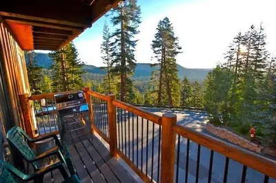 a deck with a chair and a view of the mountains at Timber Ridge Resort by 101 Great Escapes in Mammoth Lakes