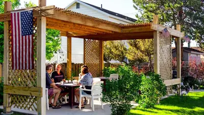 a group of people sitting at a table under a pergola at Ruby Inn Bridgeport in Bridgeport
