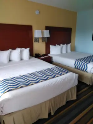 two beds in a hotel room next to each other at Travelodge by Wyndham Bishop in Bishop
