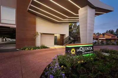 a building with a sign that reads laounge at La Quinta by Wyndham Clovis CA in Clovis