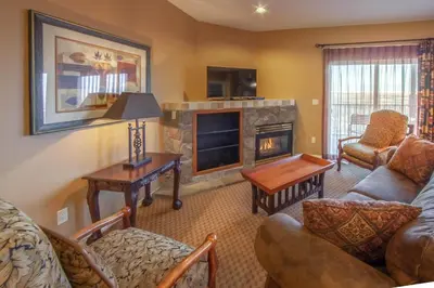 a living room with a couch and a fireplace at Holiday Inn Club Vacations - David Walley's Resort in Genoa