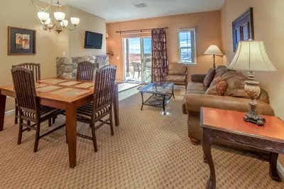 a living room with a table and a couch at Holiday Inn Club Vacations - David Walley's Resort in Genoa