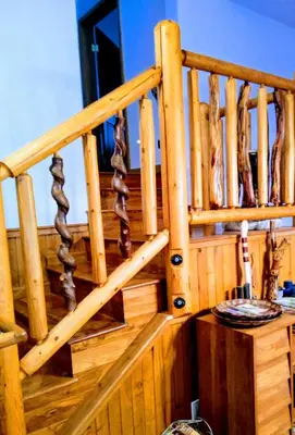 a wooden stair railing on a wooden deck at A Lovely Cabin House at Way Woods Retreat with Outdoor Hot Tub! - By Sacred Hub MGMT in Foresthill