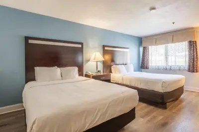 a hotel room with two beds and a window at Quality Inn near Mammoth Mountain Ski Resort in Mammoth Lakes