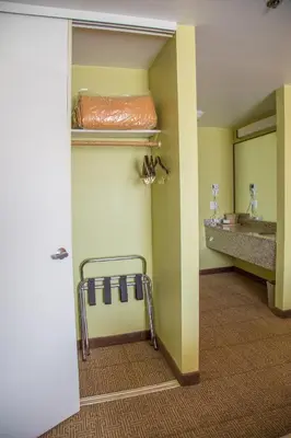 a hospital room with a bed and a sink at Quality Inn Merced Gateway to Yosemite in Merced